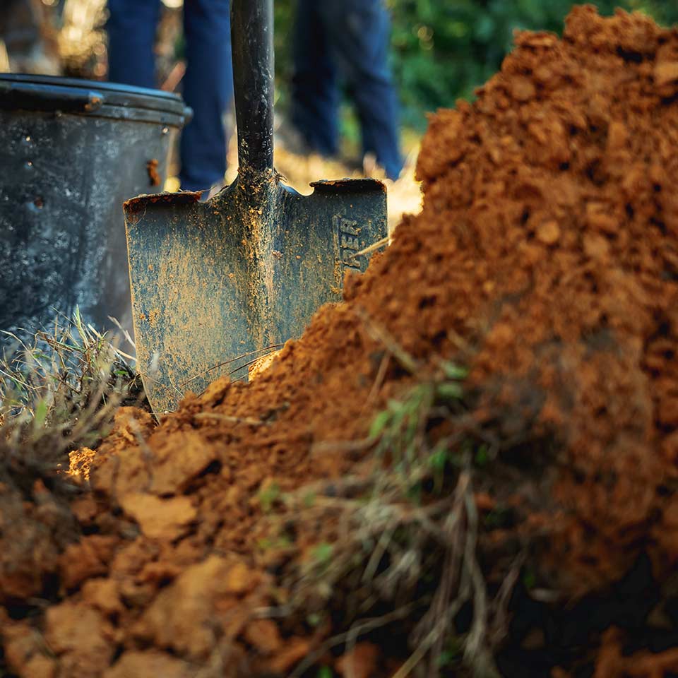 Digging soil to improve aeration and health
