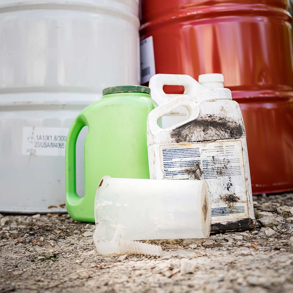 bottles and cans of unmarked chemical fertilizer